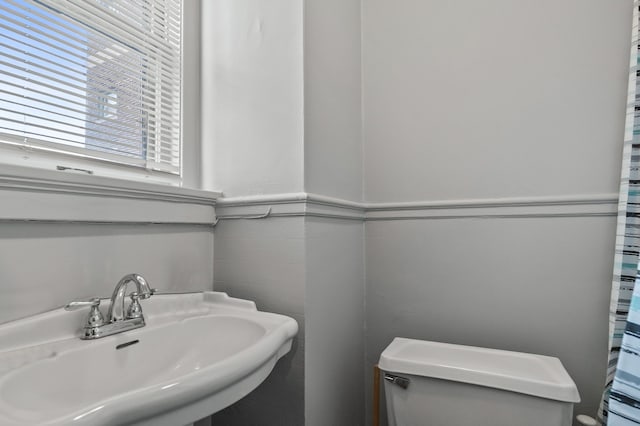 bathroom with toilet and a sink