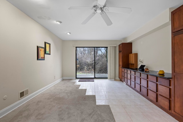 unfurnished room featuring ceiling fan and light tile patterned floors