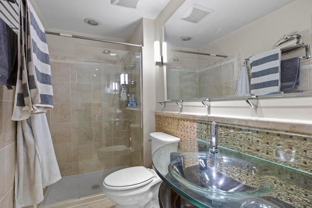 bathroom featuring tile patterned flooring, toilet, and walk in shower