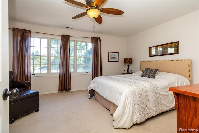 bedroom with ceiling fan and light colored carpet