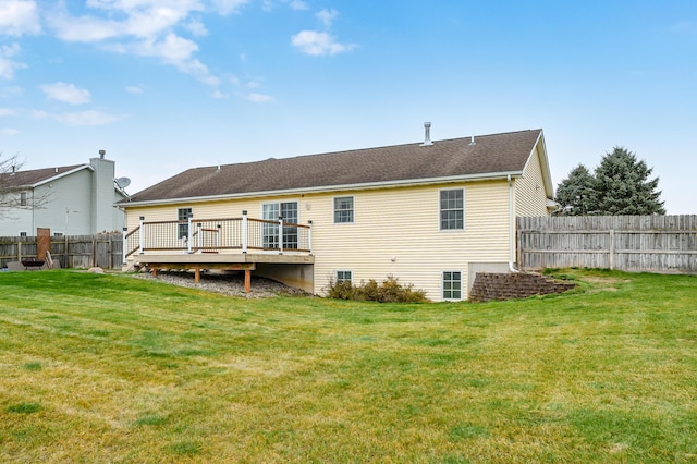 rear view of property with a yard and a wooden deck