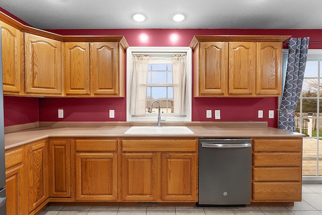 kitchen with dishwasher, light tile patterned flooring, and sink