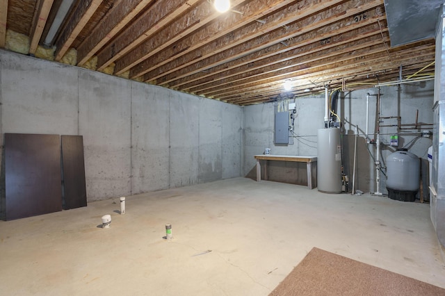 basement featuring electric panel and water heater