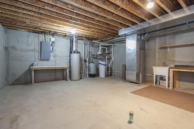 basement featuring gas water heater, sink, electric panel, and heating unit