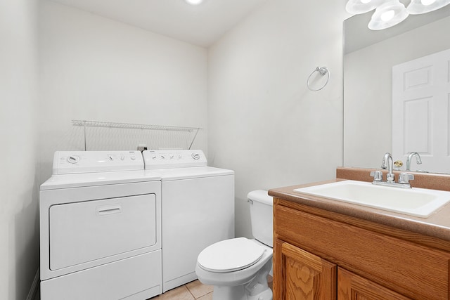 bathroom featuring tile patterned flooring, vanity, separate washer and dryer, and toilet