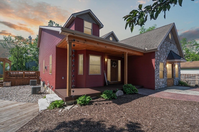 view of front of house with a patio area and central air condition unit