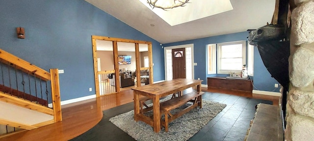 dining area featuring dark hardwood / wood-style flooring and vaulted ceiling