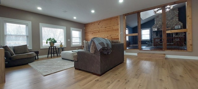 living room with vaulted ceiling and light wood-type flooring