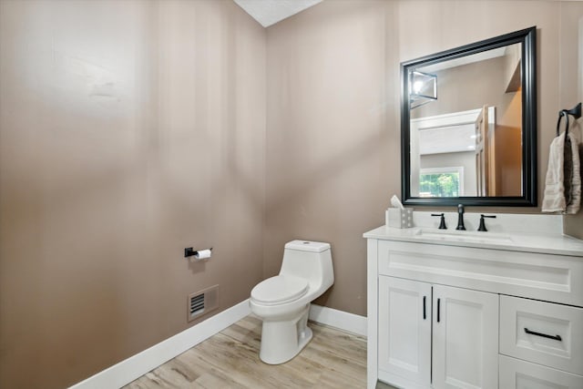 bathroom featuring hardwood / wood-style floors, vanity, and toilet