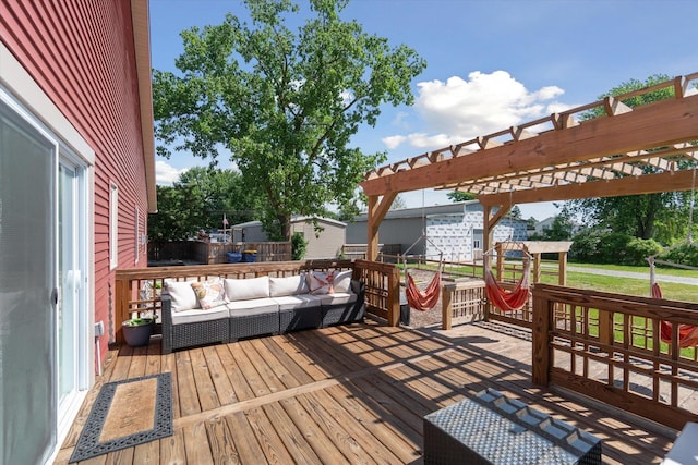 wooden deck with an outdoor living space and a pergola