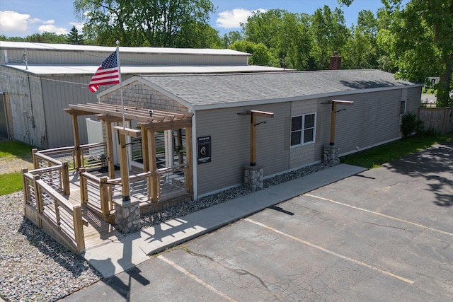 view of front of house featuring a deck and a pergola