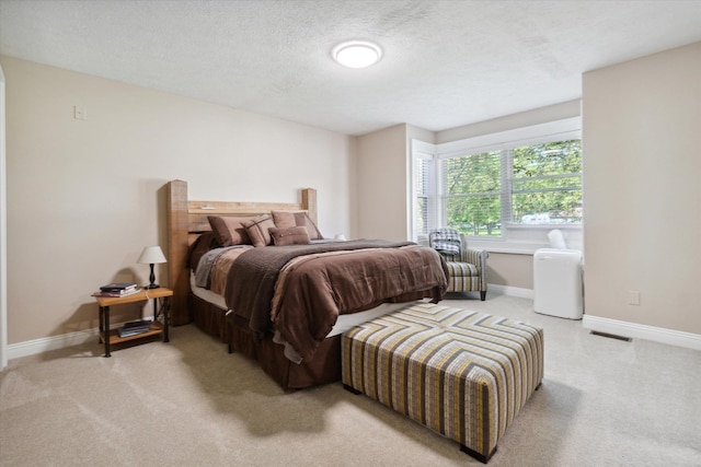 carpeted bedroom featuring a textured ceiling