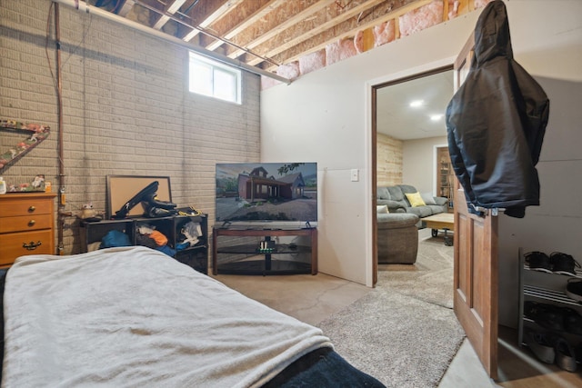 bedroom featuring brick wall