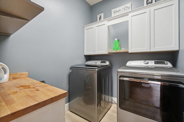 210 E Mcneil St, Corunna, MI 48817 - washroom with cabinet space, washing machine and clothes dryer, light wood finished floors, and baseboards