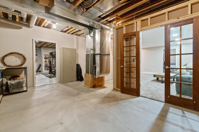 basement with french doors and heating unit