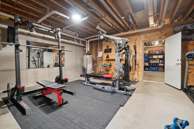 exercise room with a workshop area and water heater