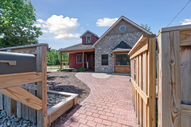 210 E Mcneil St, Corunna, MI 48817 - back of property featuring stone siding and a patio