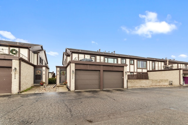 view of front of house featuring a garage and a balcony