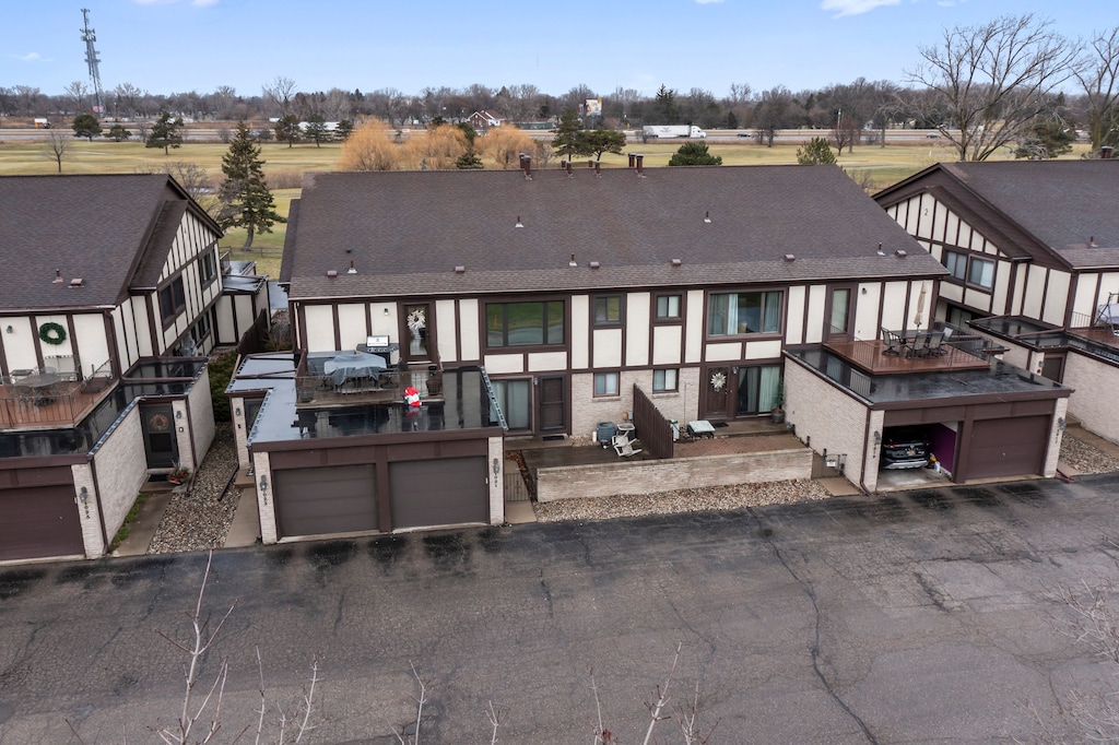 back of property with a garage