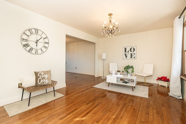 dining room with hardwood / wood-style floors and a chandelier