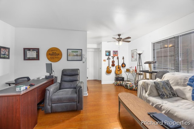 living room featuring hardwood / wood-style flooring and ceiling fan