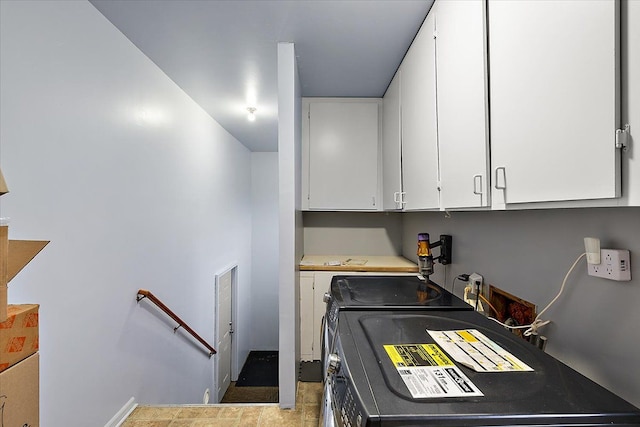 washroom featuring cabinets and washing machine and dryer