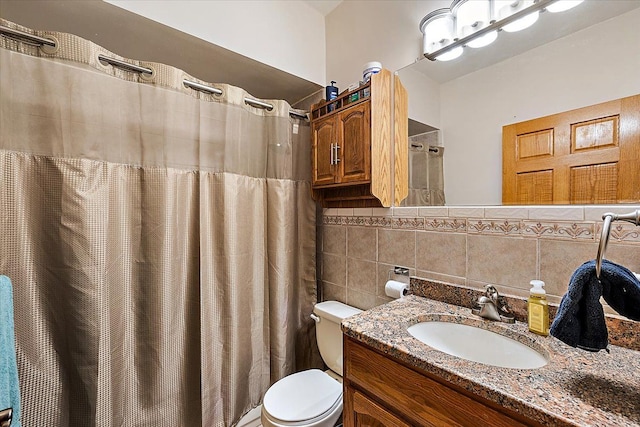 bathroom with curtained shower, tasteful backsplash, toilet, vanity, and tile walls