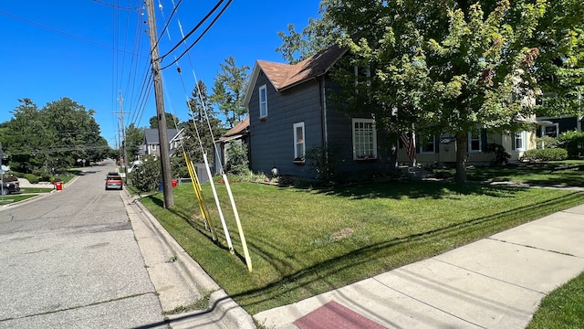 view of side of home featuring a yard