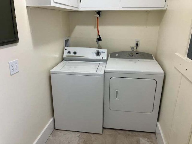 laundry room with cabinets and washing machine and clothes dryer