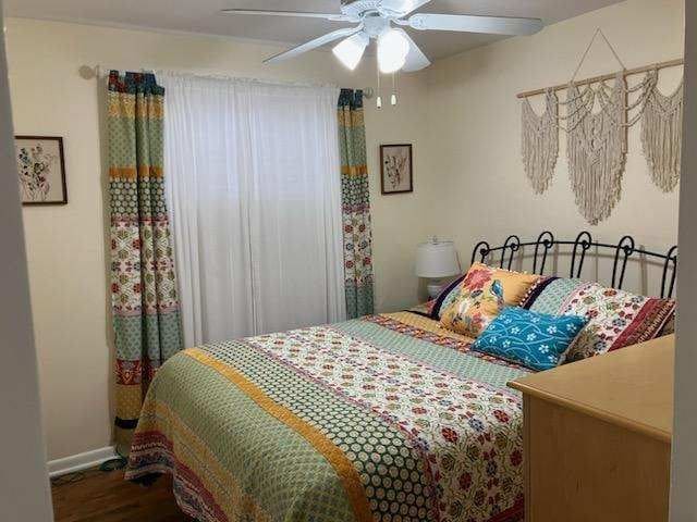 bedroom featuring ceiling fan and hardwood / wood-style floors