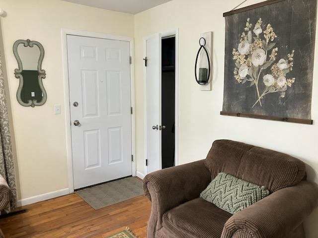 sitting room with wood-type flooring