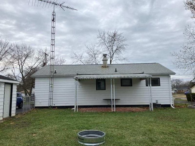 back of house with a lawn