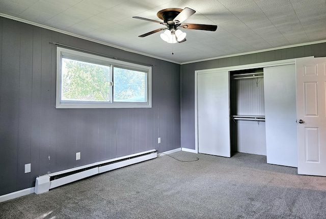 unfurnished bedroom with carpet flooring, ceiling fan, and a baseboard heating unit