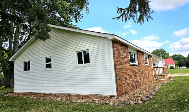 view of side of home featuring a lawn