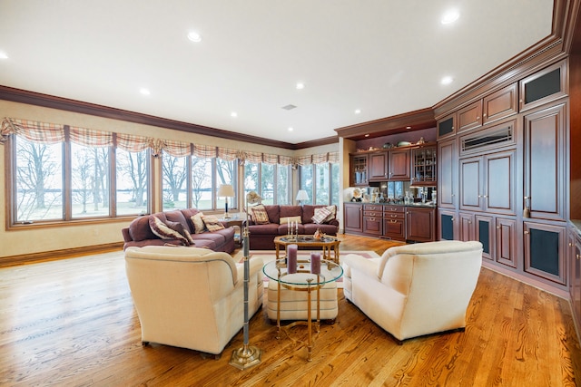 living room featuring light hardwood / wood-style floors and ornamental molding