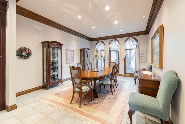 tiled dining area featuring crown molding