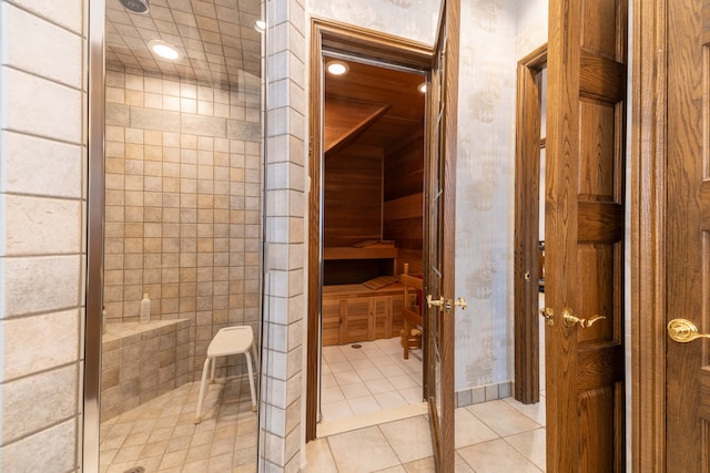 bathroom with tile patterned floors and tiled shower