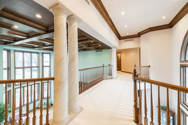 hall featuring coffered ceiling, beam ceiling, ornamental molding, and decorative columns