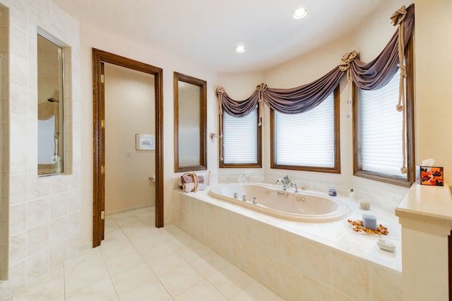 bathroom with shower with separate bathtub and tile patterned floors