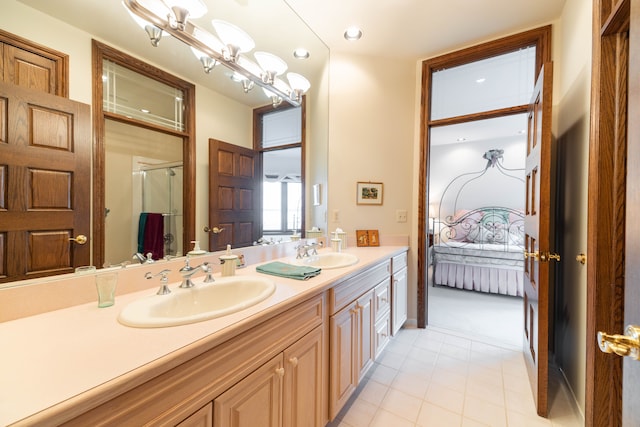 bathroom with tile patterned floors, vanity, and an enclosed shower