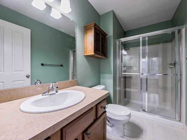 bathroom with tile patterned flooring, vanity, a shower with door, and toilet