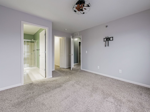 unfurnished bedroom with carpet flooring and connected bathroom