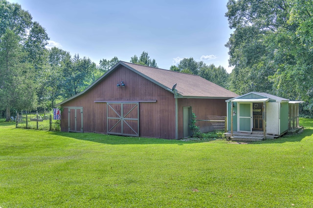 view of outbuilding with a yard