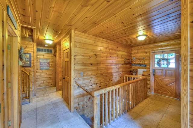 hall featuring wood walls, wooden ceiling, and rustic walls