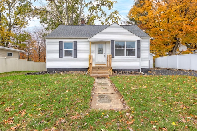 bungalow-style home with a front lawn