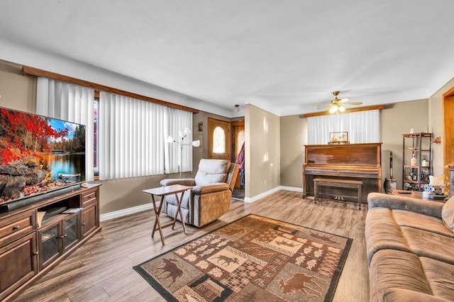 living room featuring ceiling fan and light wood-type flooring