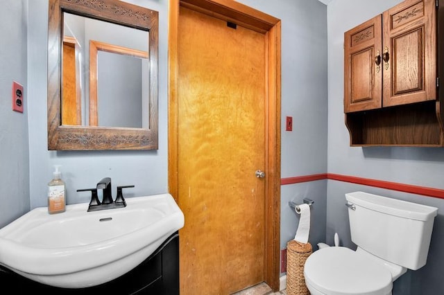 bathroom featuring vanity and toilet