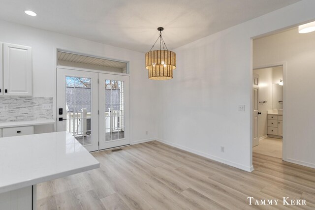 unfurnished dining area with light wood-type flooring