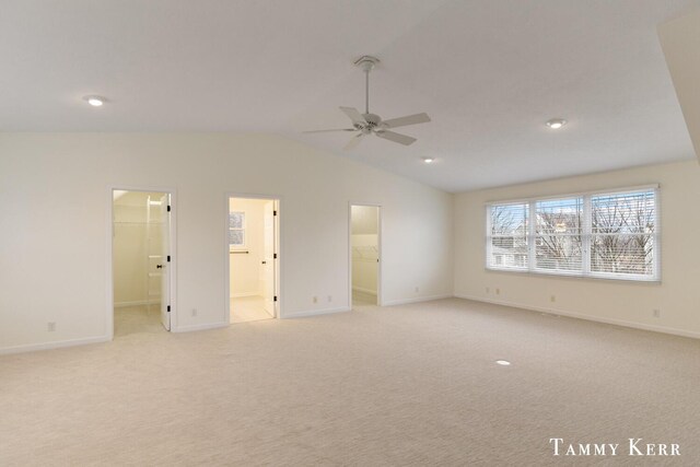 unfurnished bedroom with connected bathroom, ceiling fan, a walk in closet, light carpet, and a closet