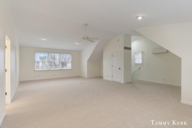 additional living space with light colored carpet, ceiling fan, and lofted ceiling